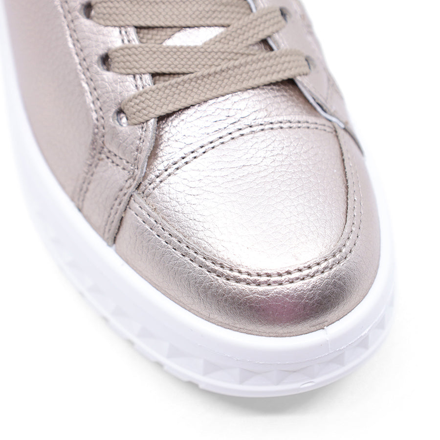 Silver metallic sneaker with leopard print accents on a white background