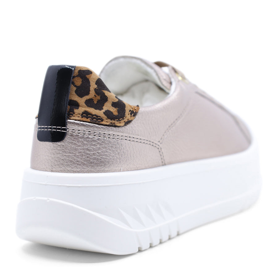 Silver metallic sneaker with leopard print accents on a white background