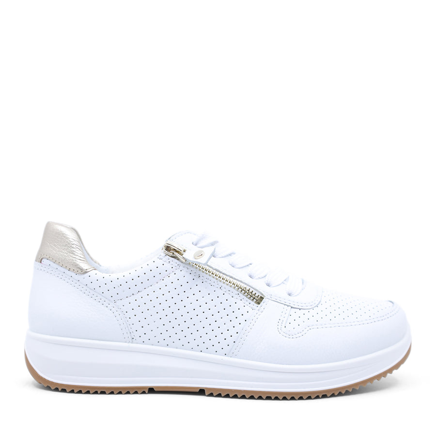 White sneaker with gold accents on a white background