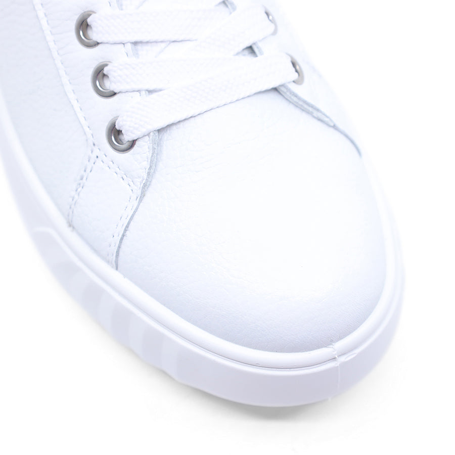 Close-up of a white sneaker on a light gray background