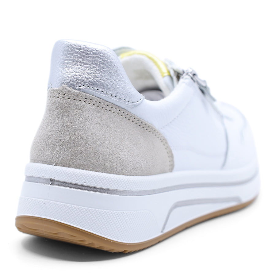 White sneaker with a grey and yellow patch on a white background