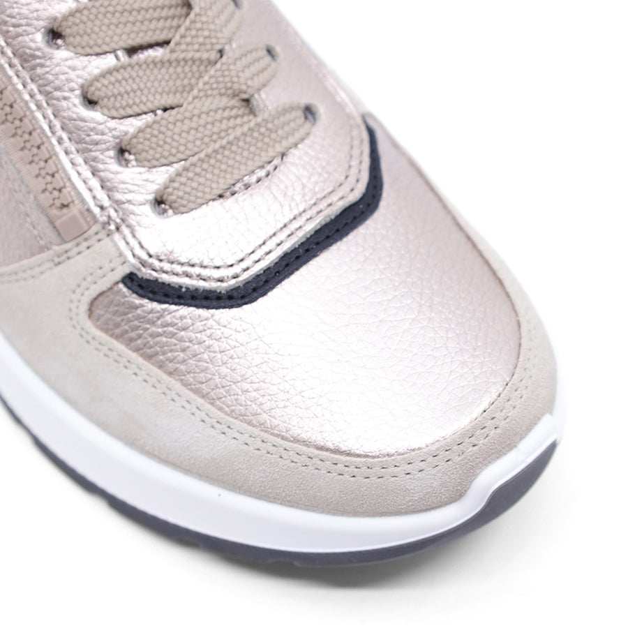 Grey metallic sneaker with black accents on a white background