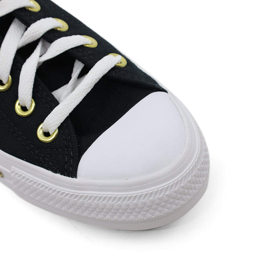 front view of black lace up sneaker with gold stud details along the white sole