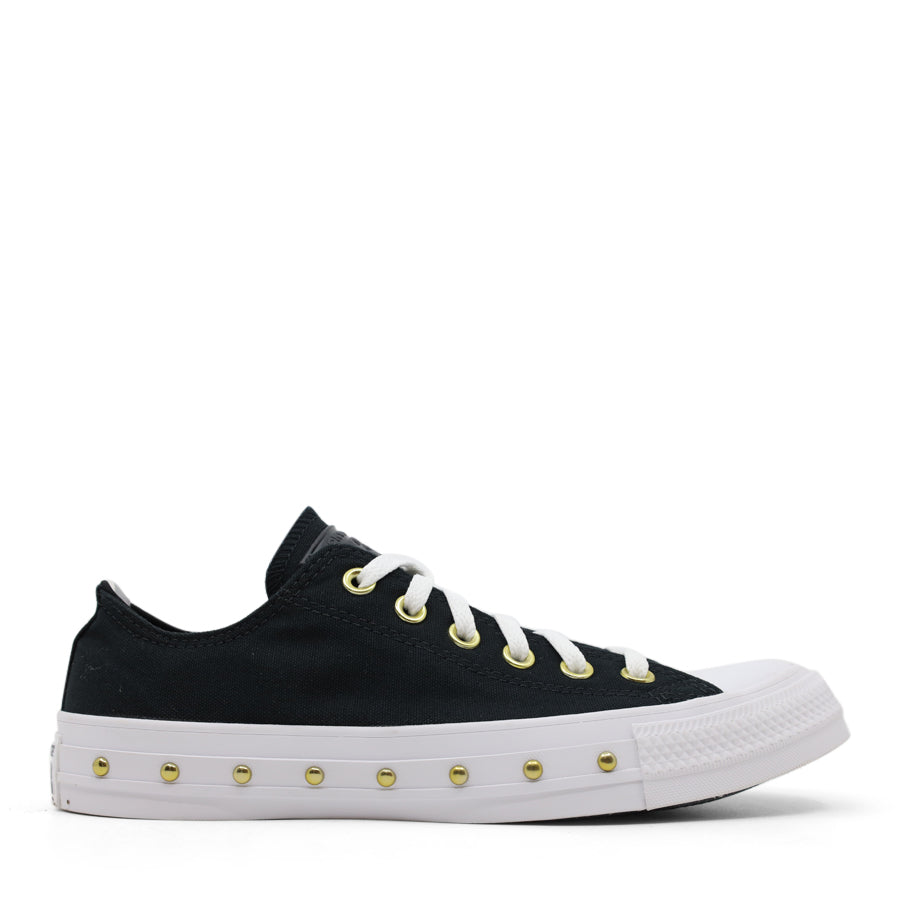 side view of black lace up sneaker with gold stud details along the white sole