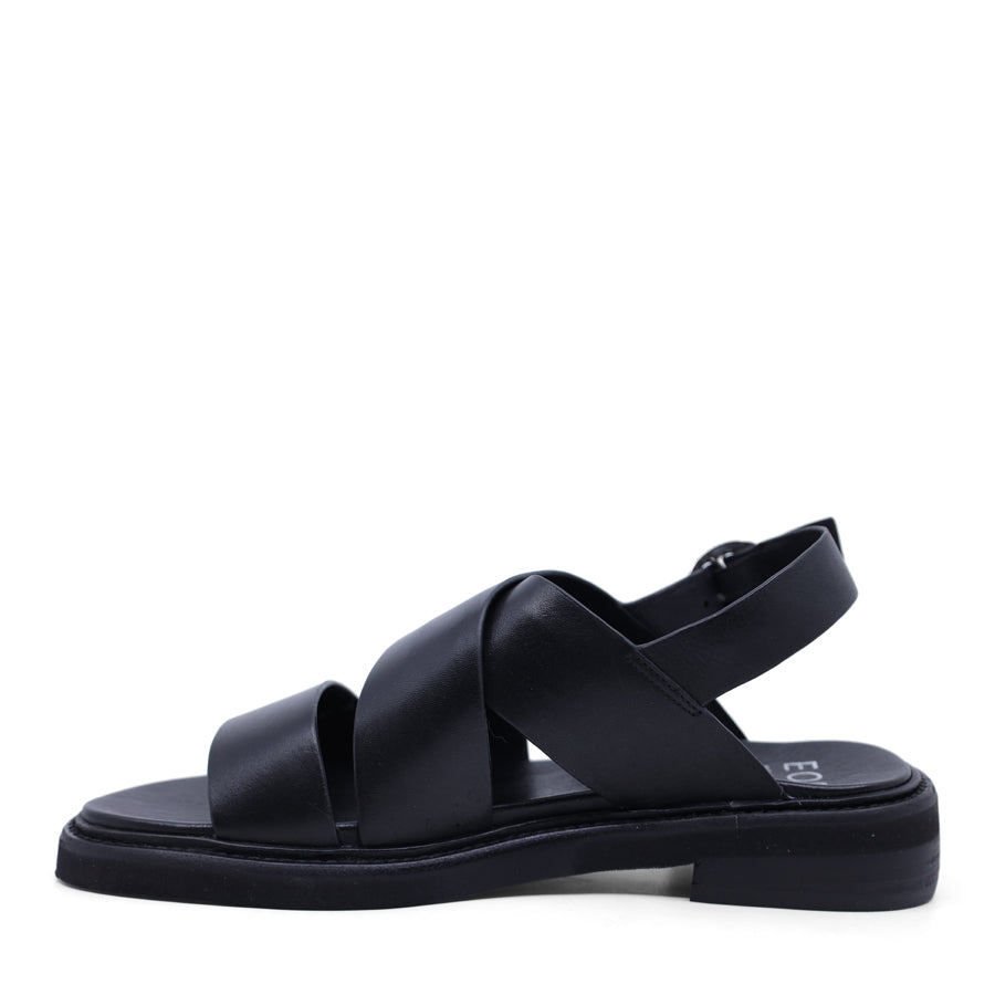 Black sandal with criss-cross straps and sling back buckle closure