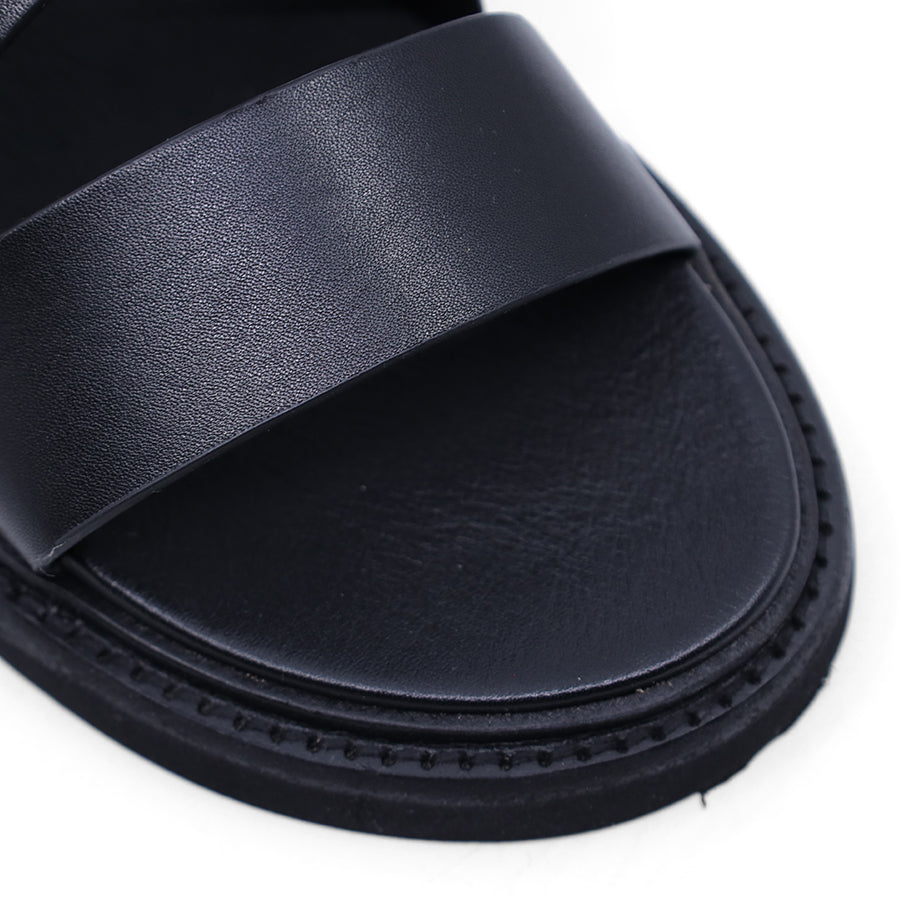 Black sandal with criss-cross straps and sling back buckle closure