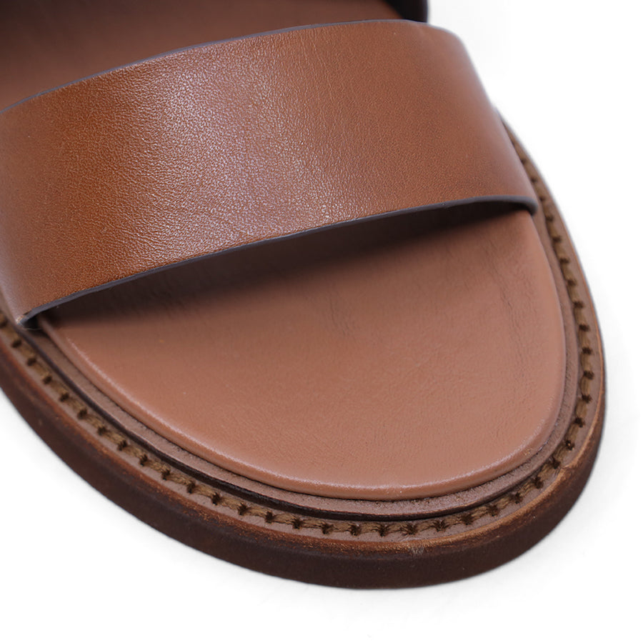 Brandy brown sandal with criss-cross straps and sling back buckle closure