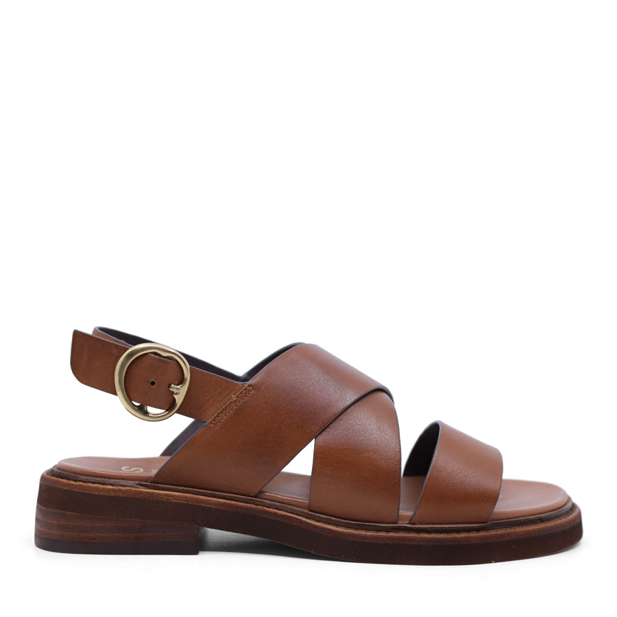 Black sandal with criss-cross straps and sling back buckle closure