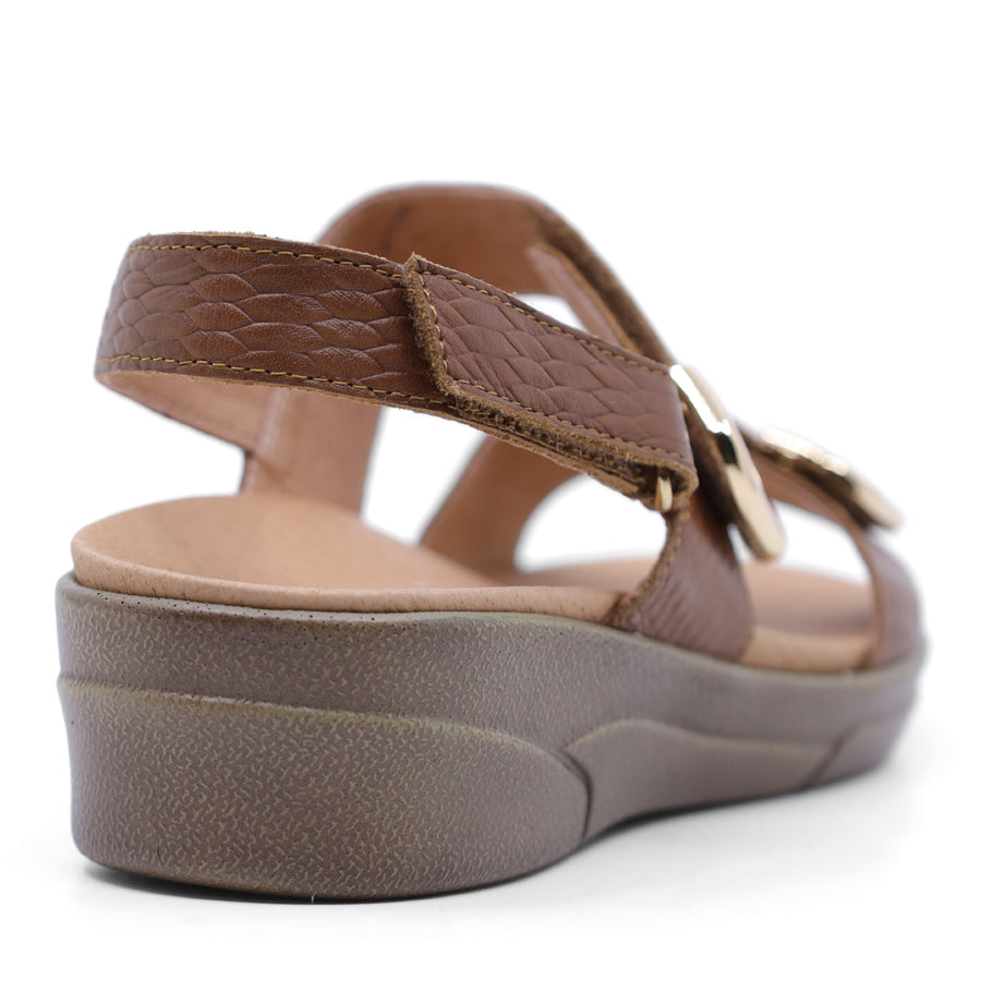 caramel brown print leather velcro sandal with a buckle strap and a flat sole.
