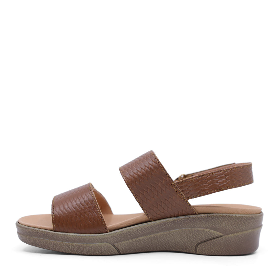 caramel brown print leather velcro sandal with a buckle strap and a flat sole.