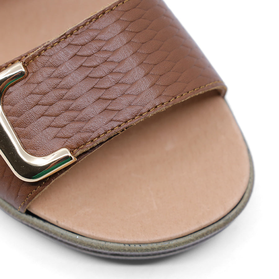 caramel brown print leather velcro sandal with a buckle strap and a flat sole.