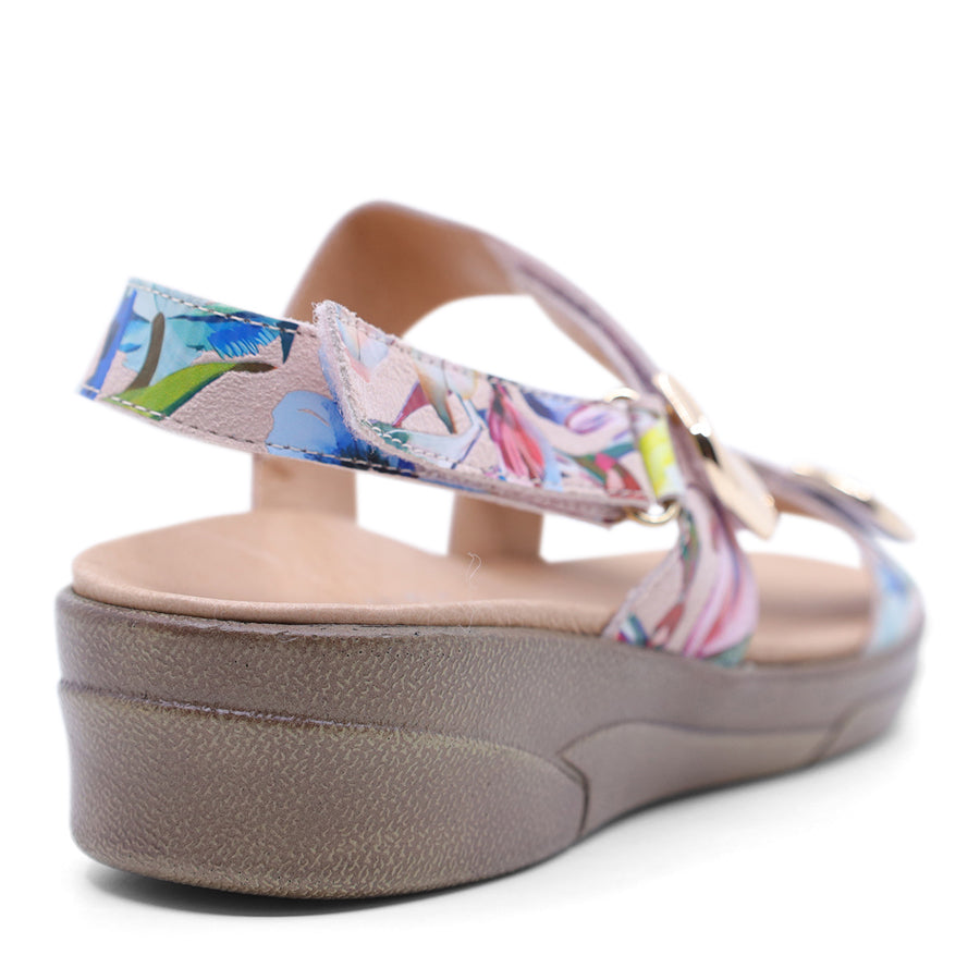 white floral print leather velcro sandal with a buckle strap and a flat sole.