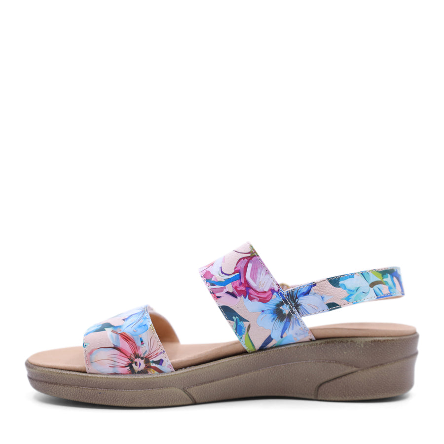 white floral print leather velcro sandal with a buckle strap and a flat sole.