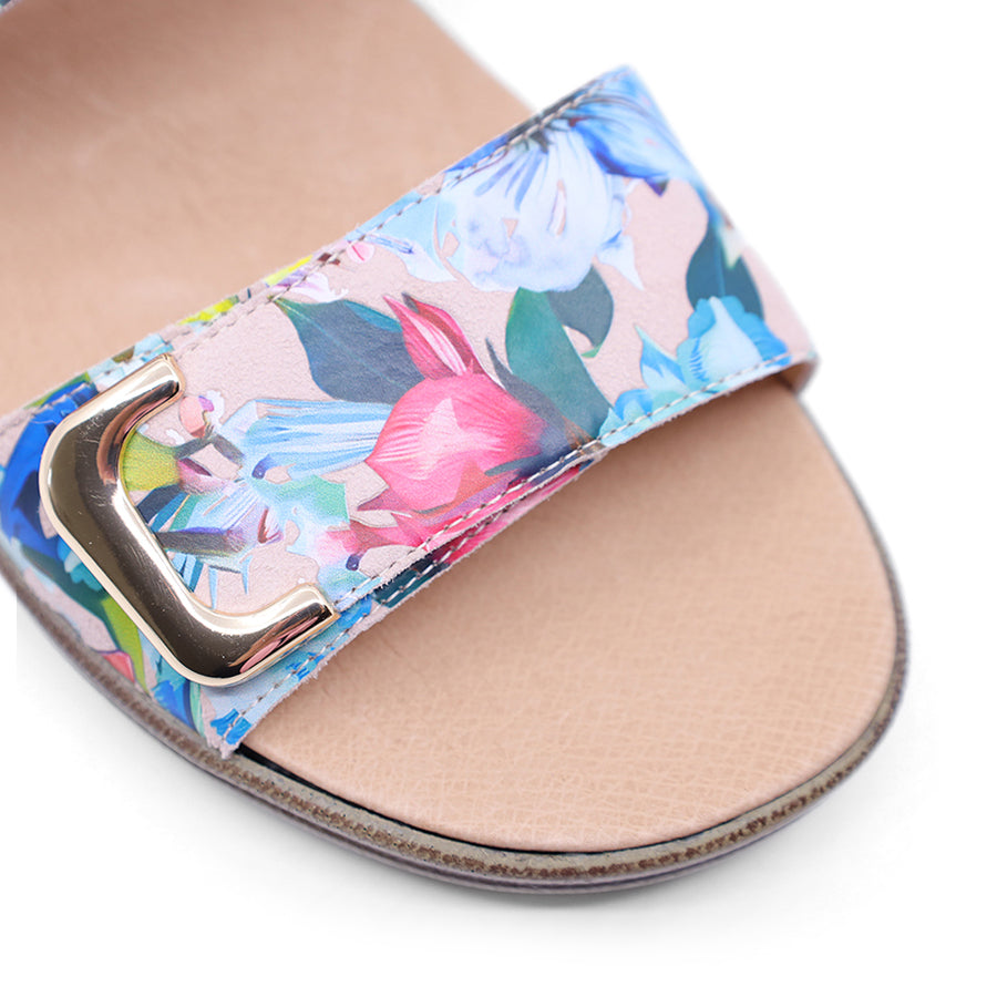 white floral print leather velcro sandal with a buckle strap and a flat sole.