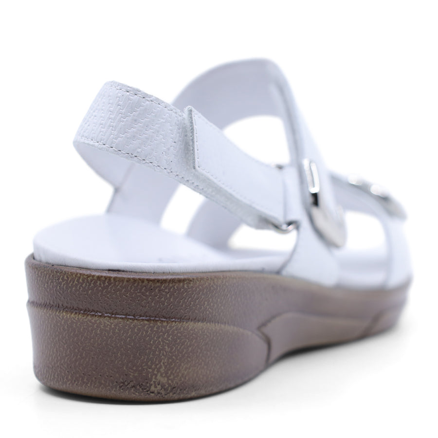 white print leather velcro sandal with a buckle strap and a flat sole.