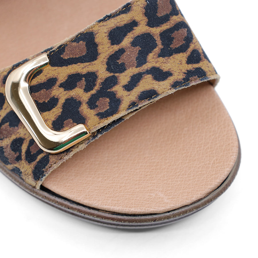 brown leopard print leather velcro sandal with a buckle strap and a flat sole.