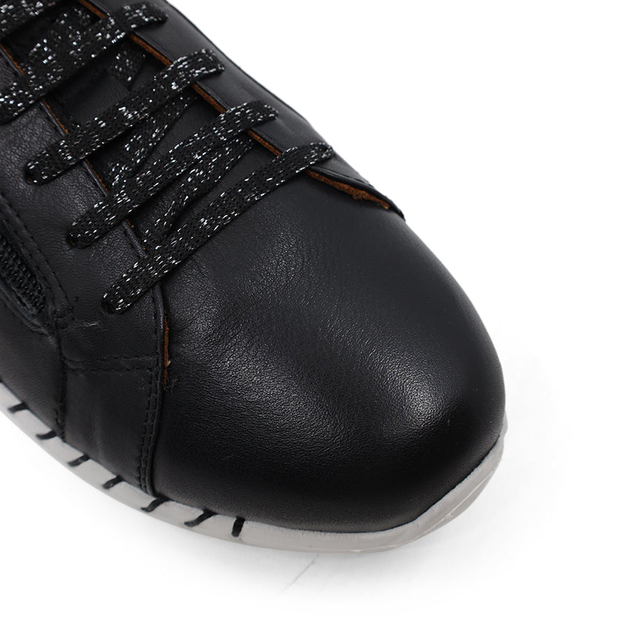 front view of black lace up sneaker with side zip and white sole