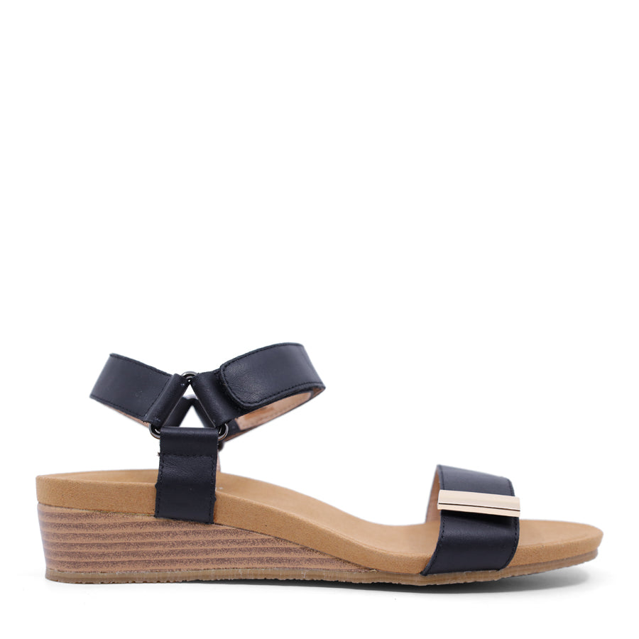 White wedge sandal with a wooden wedge sole and velcro strap