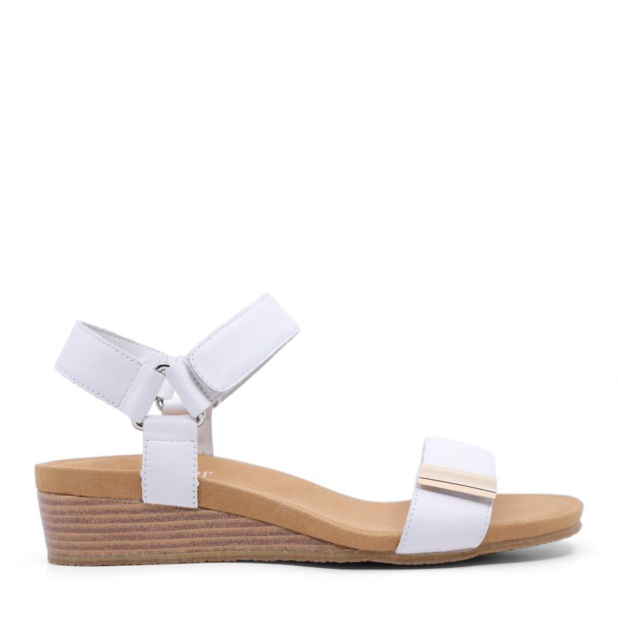 White wedge sandal with a wooden wedge sole and velcro strap