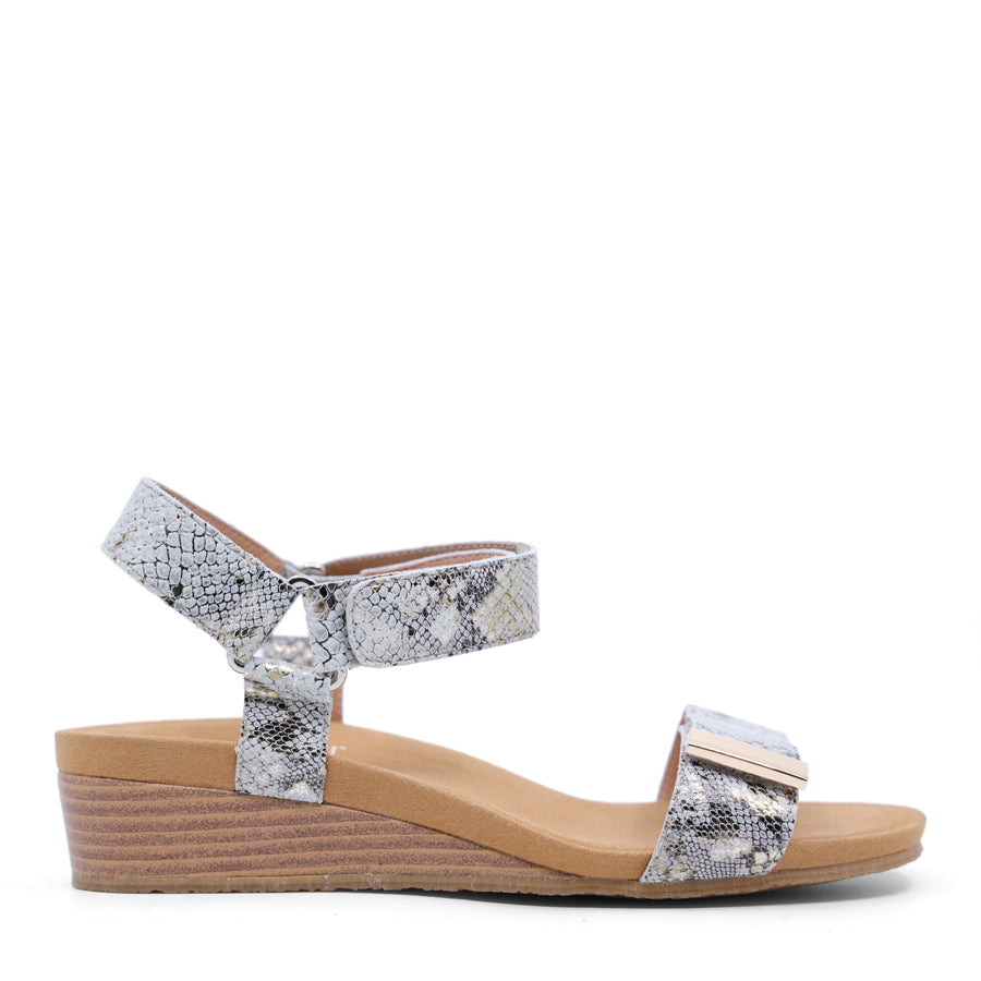White wedge sandal with a wooden wedge sole and velcro strap