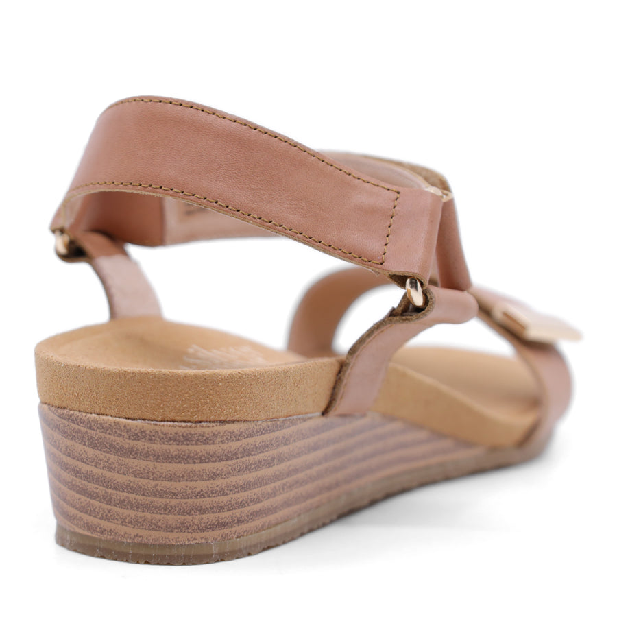 tan brown wedge sandal with a wooden wedge sole and velcro strap