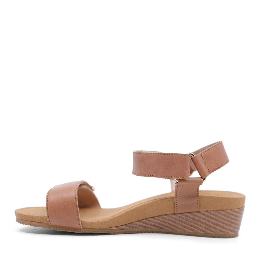 tan brown wedge sandal with a wooden wedge sole and velcro strap