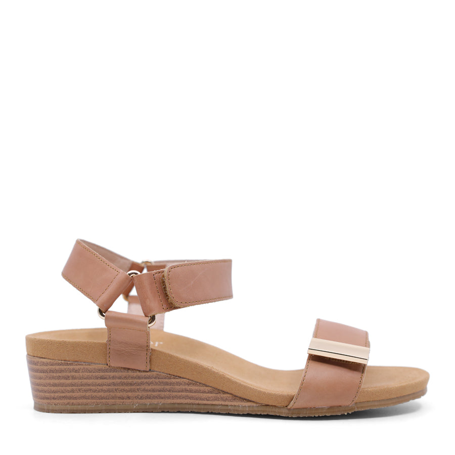 tan brown wedge sandal with a wooden wedge sole and velcro strap